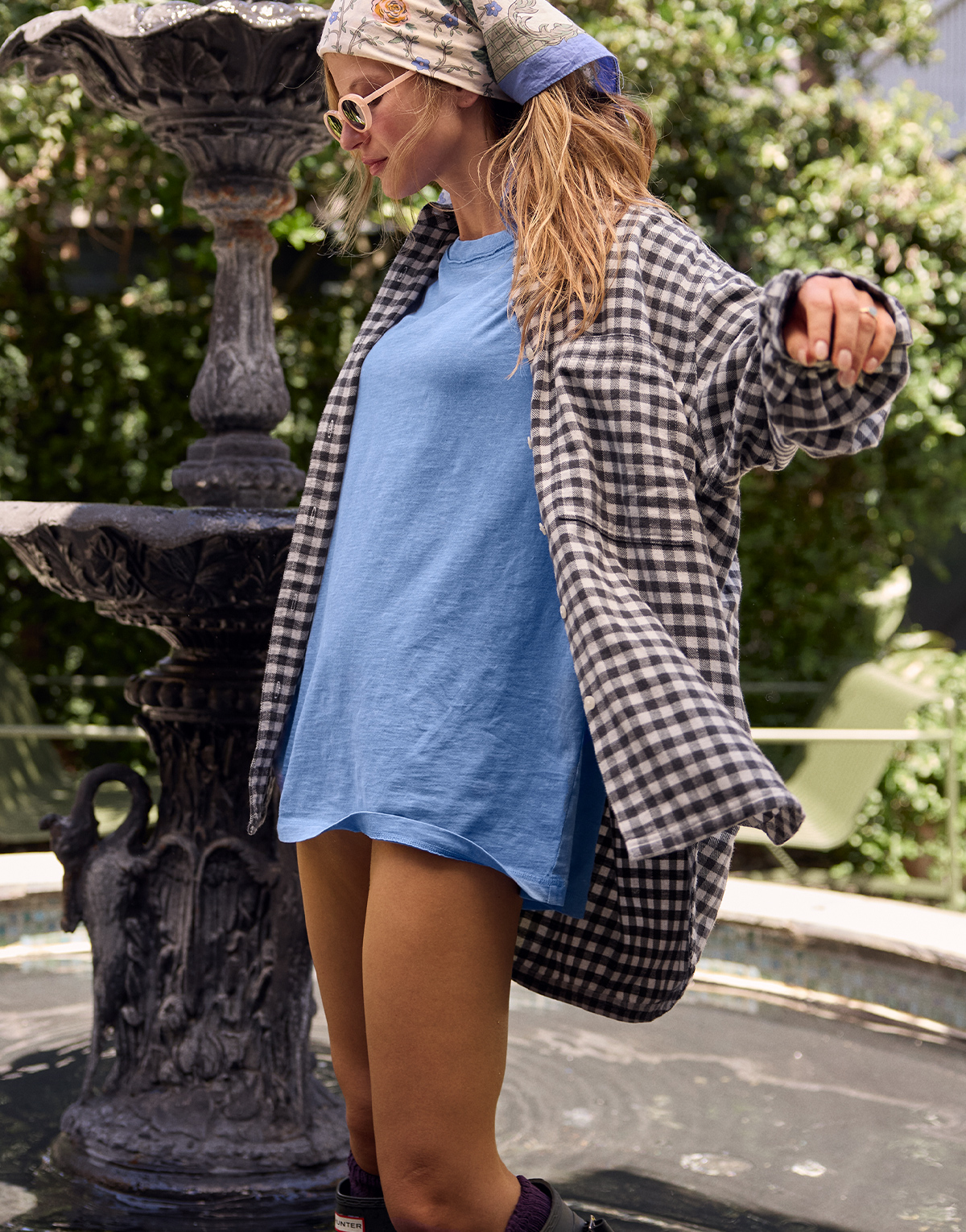 A girl wearing a plaid shirt over a t-shirt dress for fall.