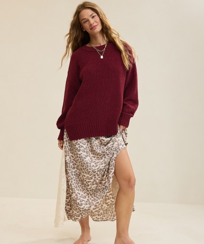 A woman wearing an Aerie sweater and maxi skirt.