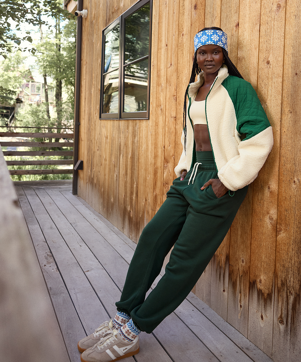 A woman wearing a jacket and joggers from OFFLINE by Aerie.