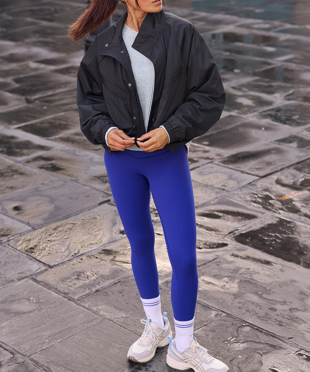 A woman wearing blue OFFLINE by Aerie leggings.