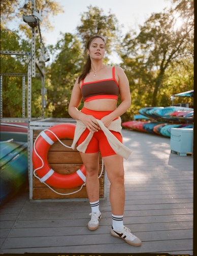 Woman in red OFFLINE by Aerie biker shorts and coordinating sports bra.