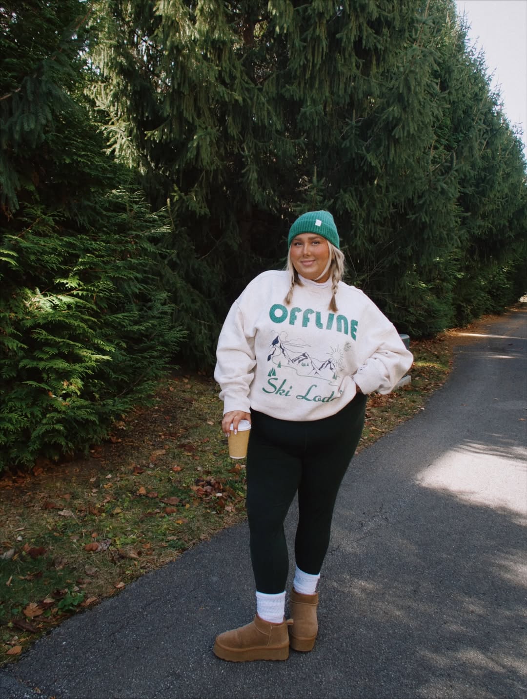 Woman in OFFLINE by Aerie crewneck and leggings.