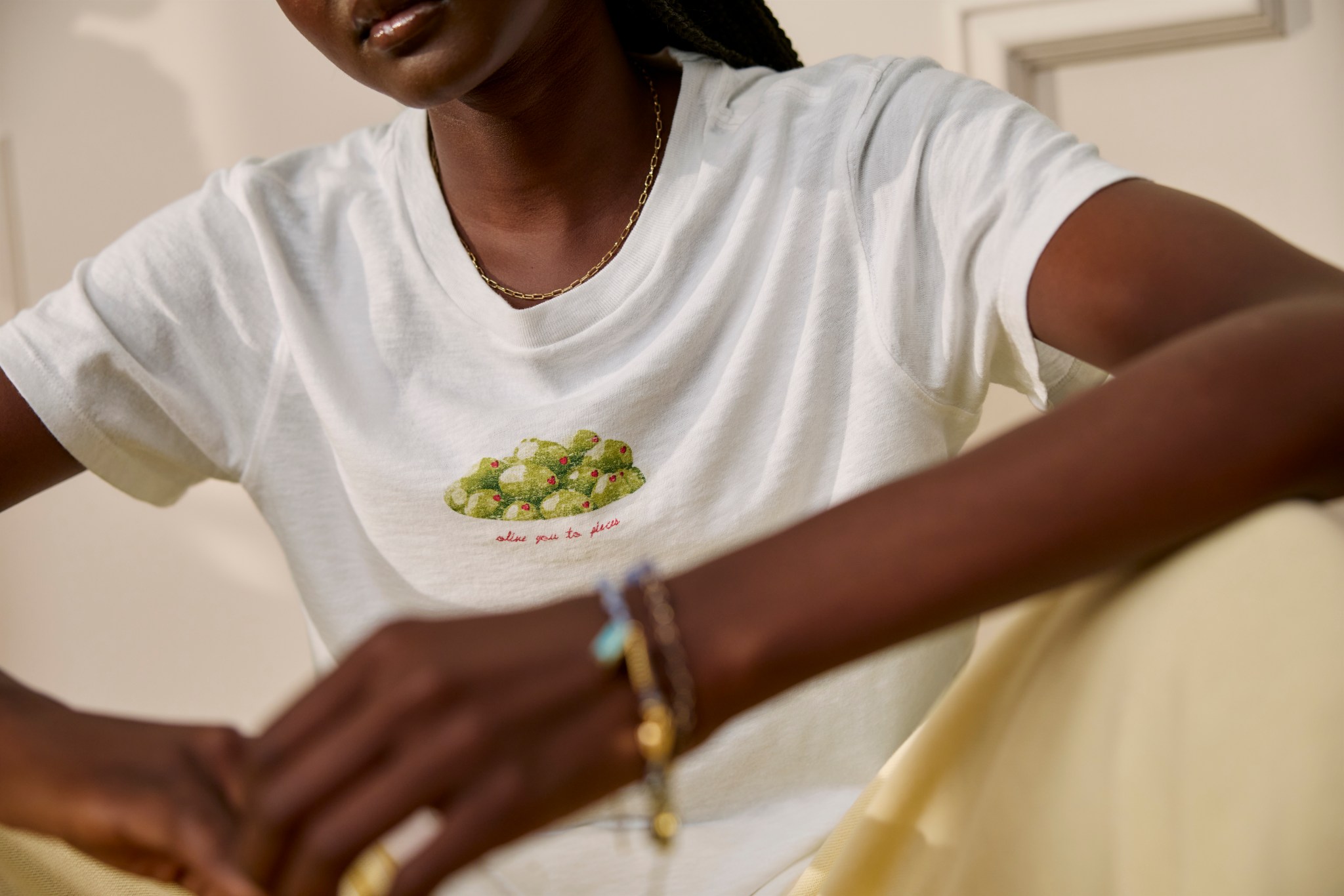 Woman in a white graphic Aerie t-shirt.