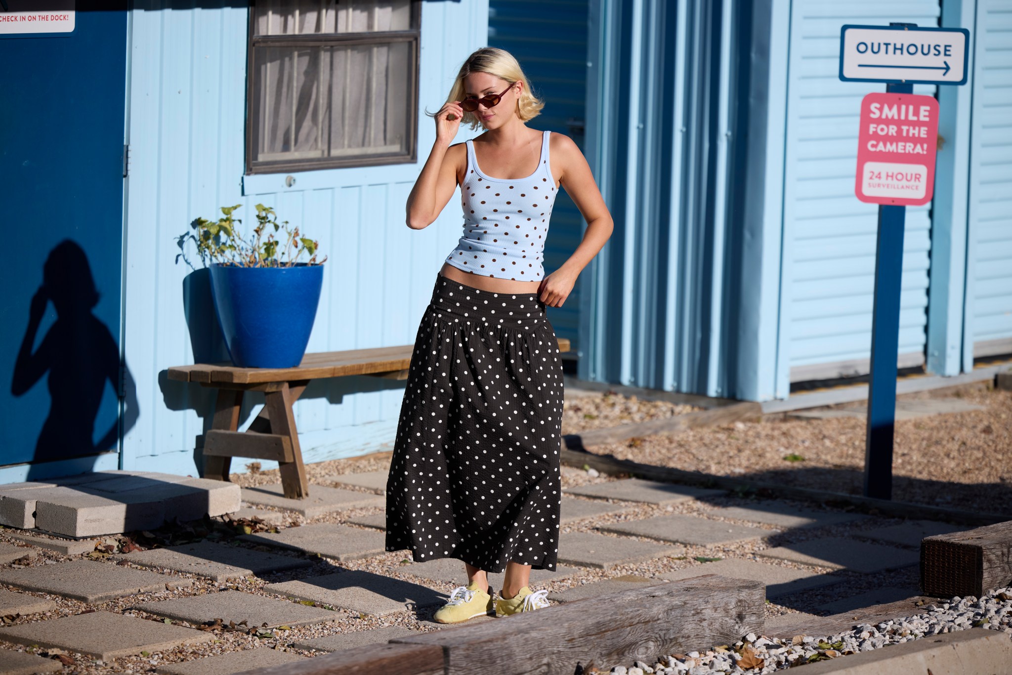 Woman in matching polka dot top and skirt from Aerie.