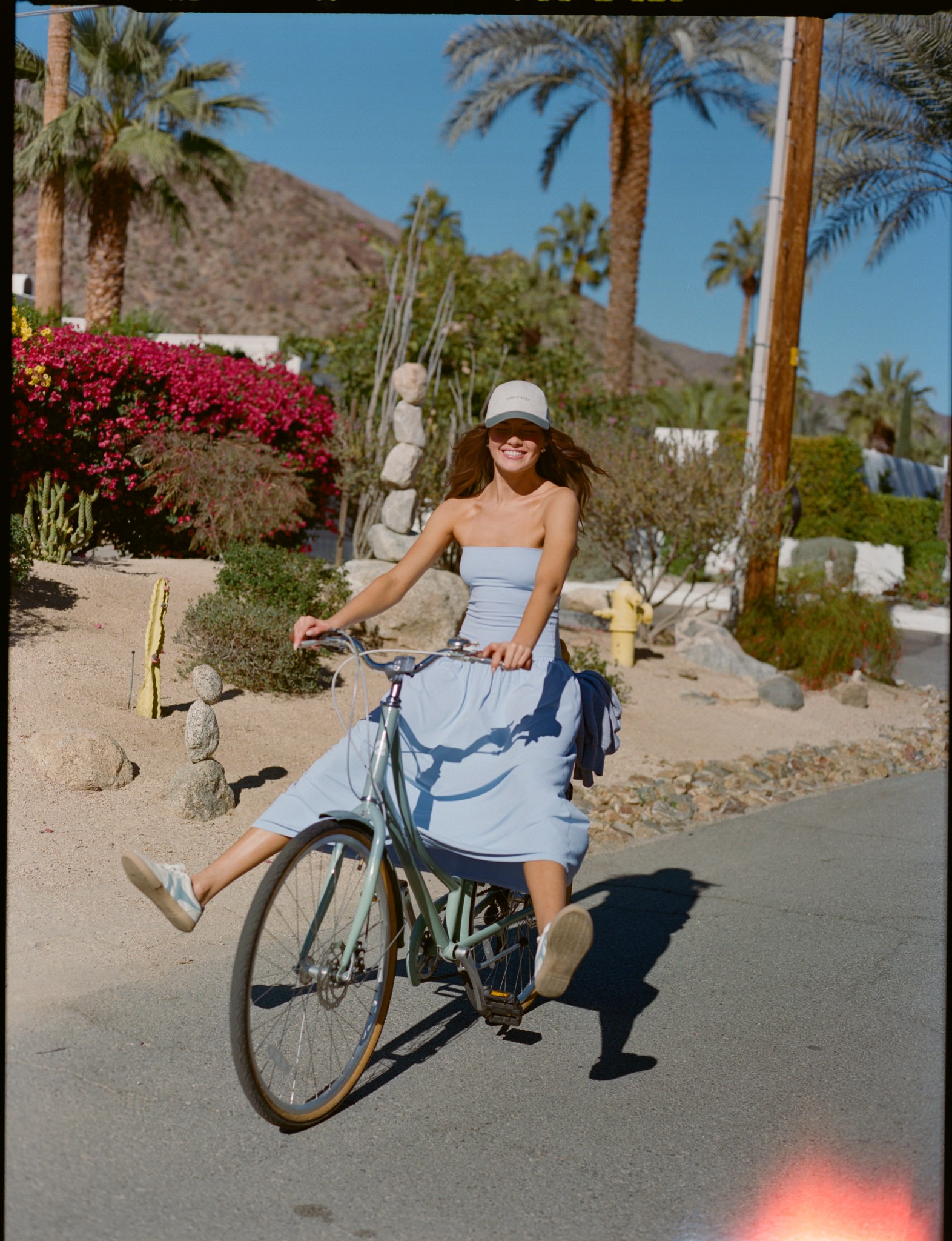 Woman biking in Aerie maxi dress.