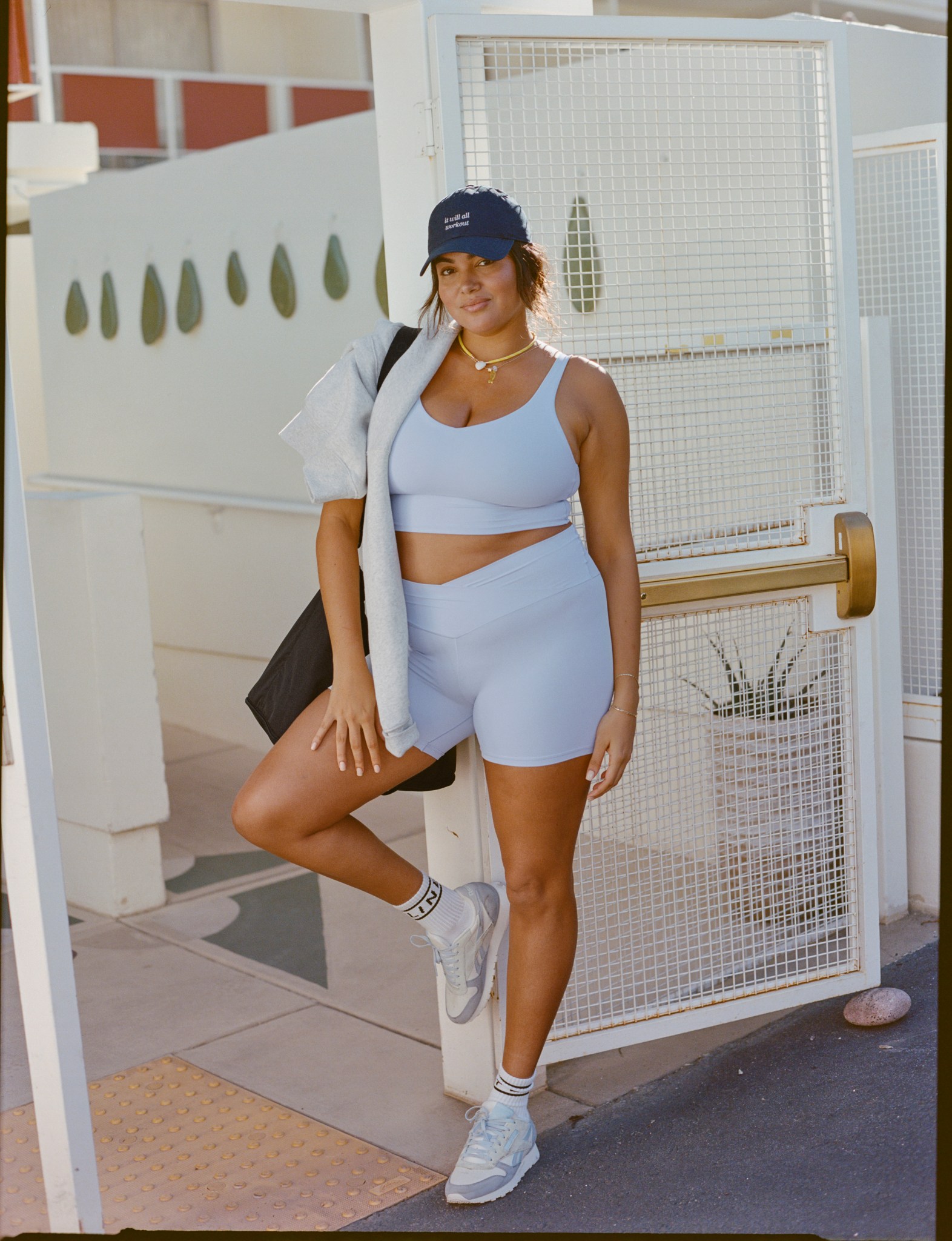 Woman in matching OFFLINE sports bra and biker shorts.