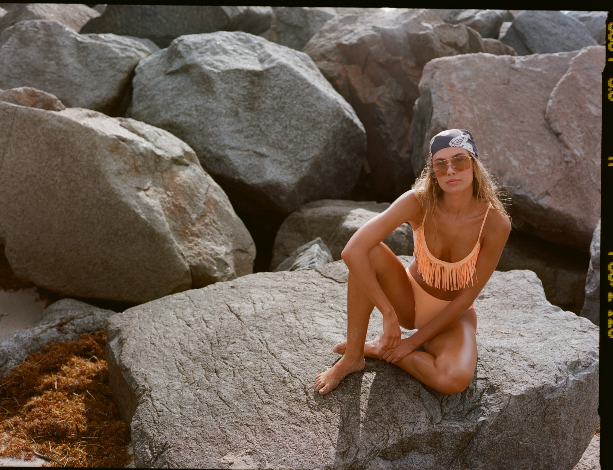 Woman wearing Aerie fringe bikini.