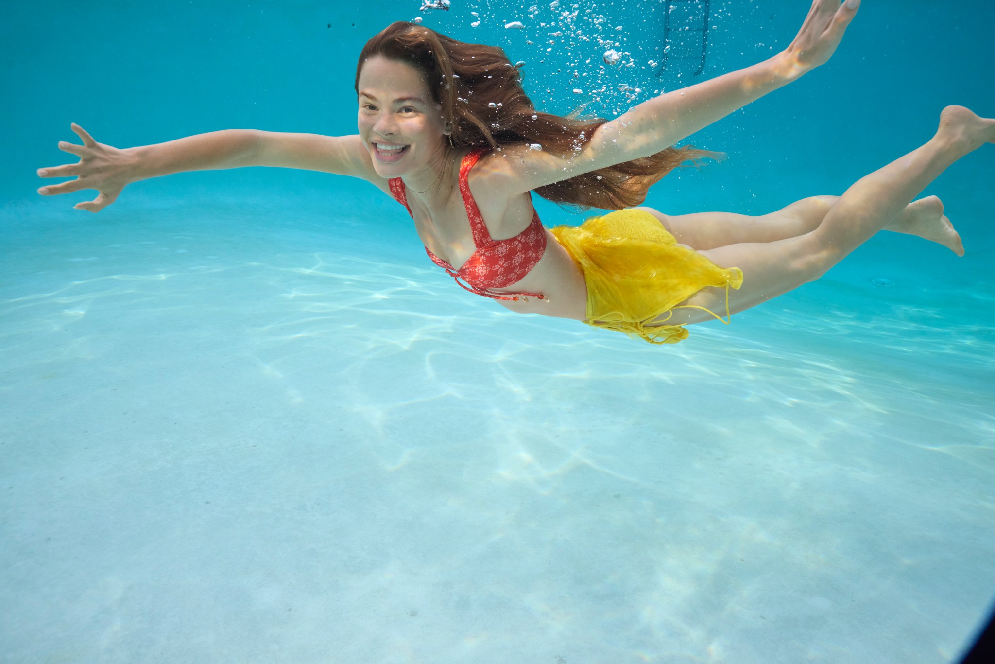 Woman wearing Aerie bikini in a pool.
